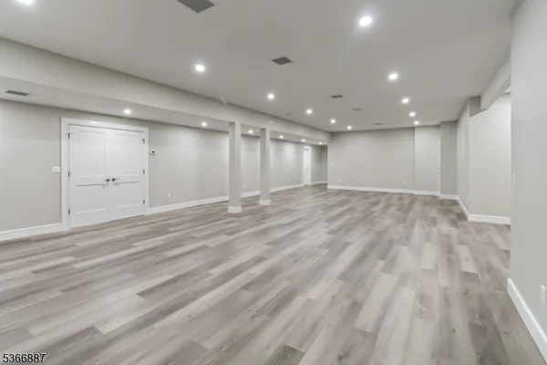 an empty room with a projector and entrance