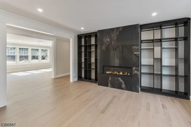 a kitchen with stainless steel appliances granite countertop a refrigerator and a wooden floor