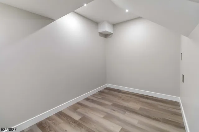 an empty room with a projector and entrance