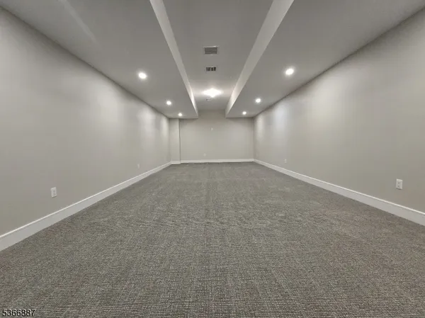 a living room with fireplace furniture and a garden