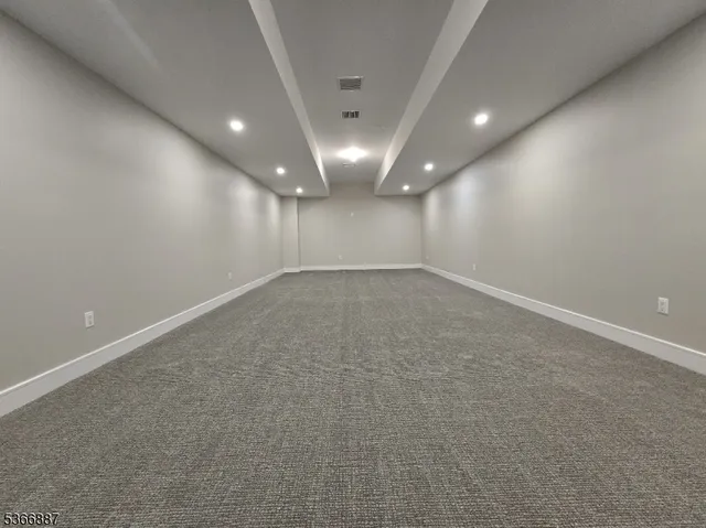 a living room with fireplace furniture and a garden