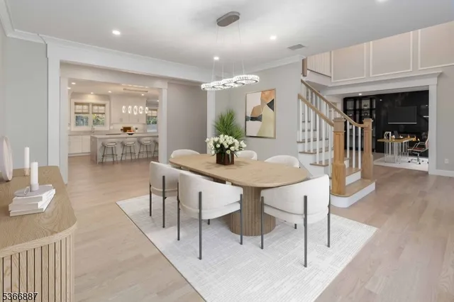 a dining room with furniture and wooden floor