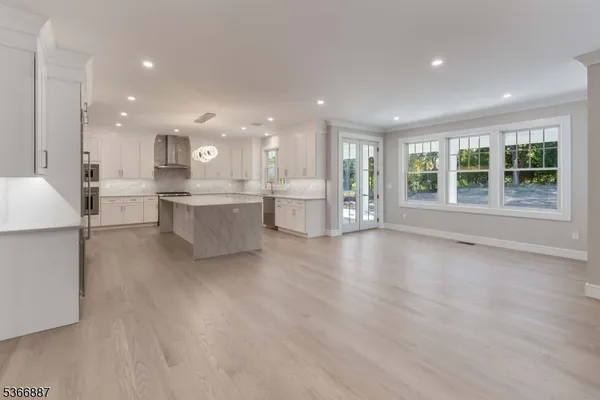 a large white kitchen with a large window