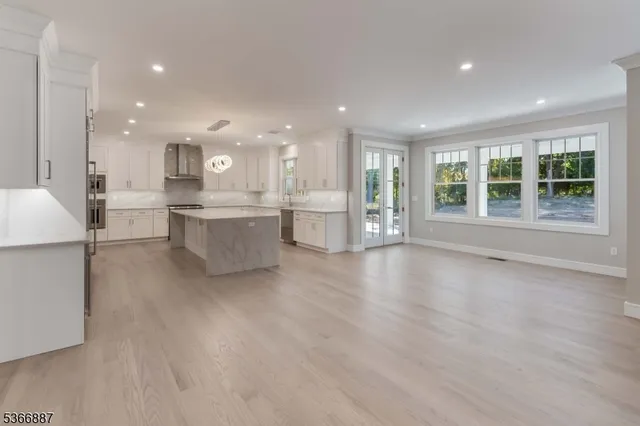 a large white kitchen with a large window