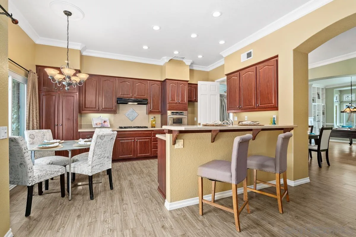 2284 Rolling Ridge Road Chula Vista, CA 91914 - Photo 10 of 44 a dining table chairs wooden floor and kitchen view