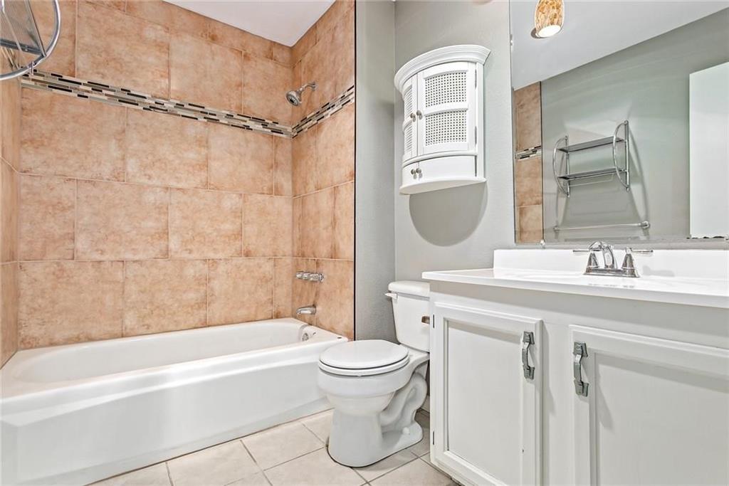 5000 Goodwin Drive Plano, TX 75023 - Photo 11 of 16 a bathroom with a granite countertop sink toilet and shower