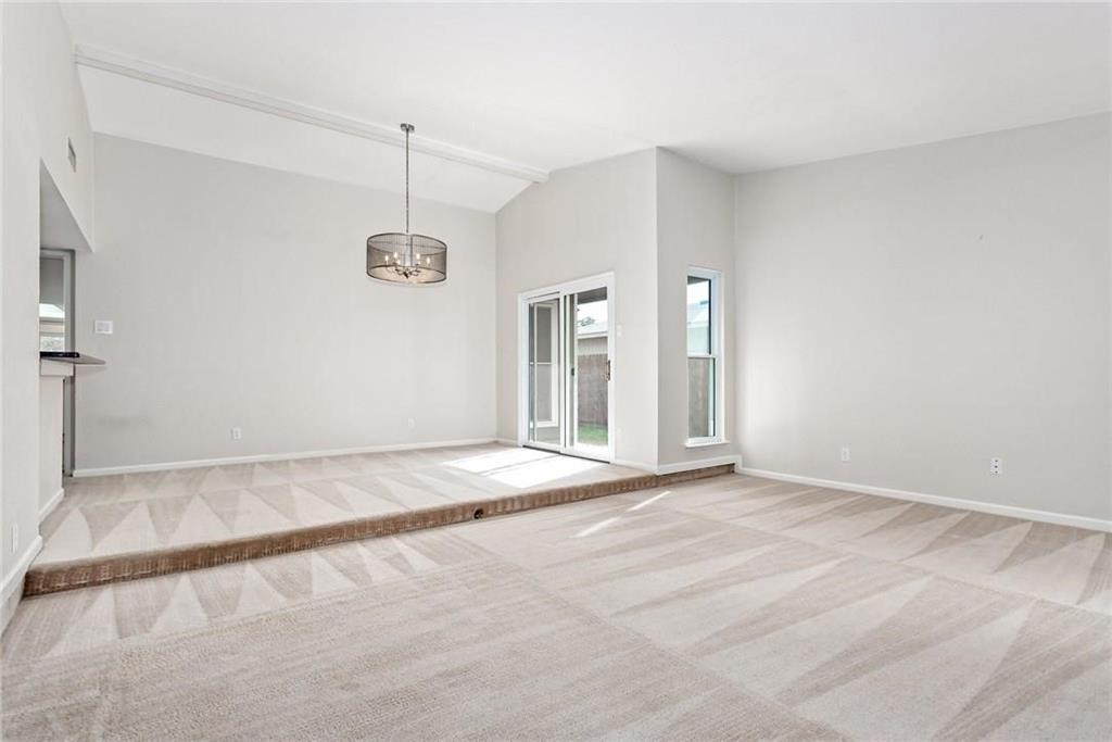 5000 Goodwin Drive Plano, TX 75023 - Photo 6 of 16 a view of an empty room with window and chandelier fan