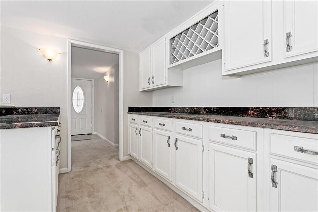 5000 Goodwin Drive Plano, TX 75023 - Photo 7 of 16 a kitchen with granite countertop a sink cabinets and stainless steel appliances