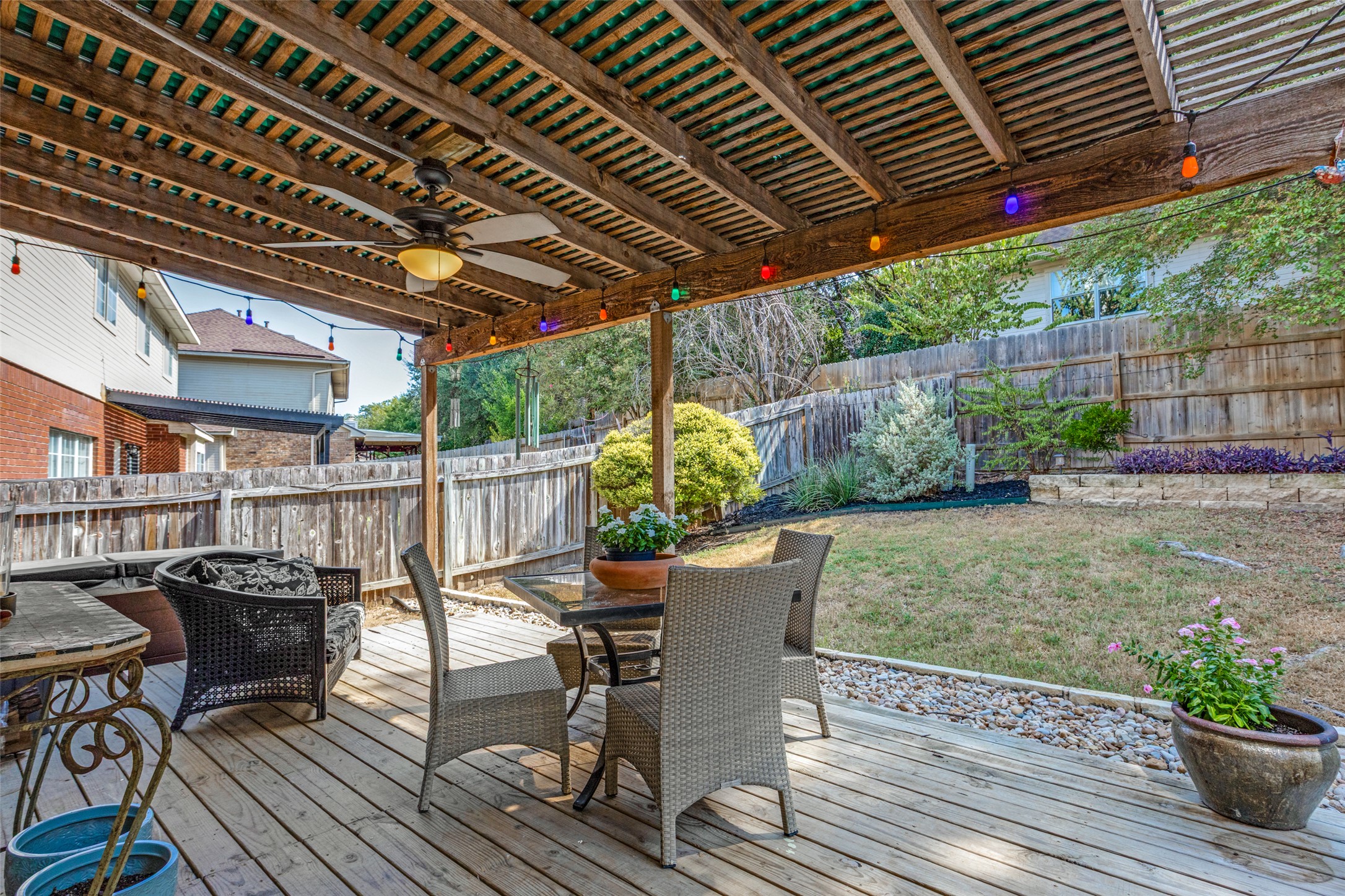 3803 Caney Creek Road Austin, TX 78732 - Photo 19 of 21 A spacious wooden deck with a pergolas covers this backyard seating area.
