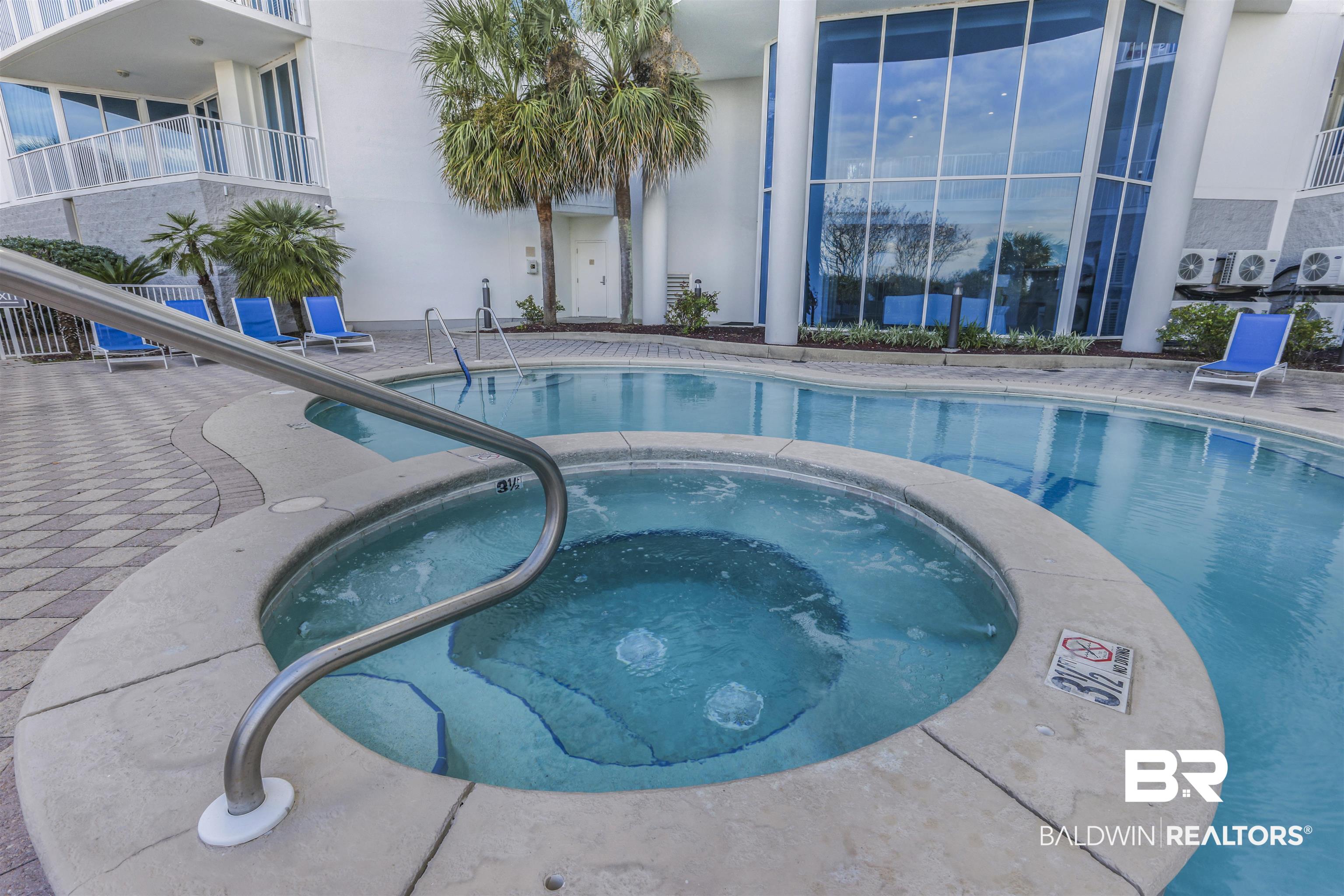 28250 Canal Road, Unit 106 Orange Beach, AL 36561 - Photo 37 of 50 Indoor pool featuring an in-ground hot tub and a patio area