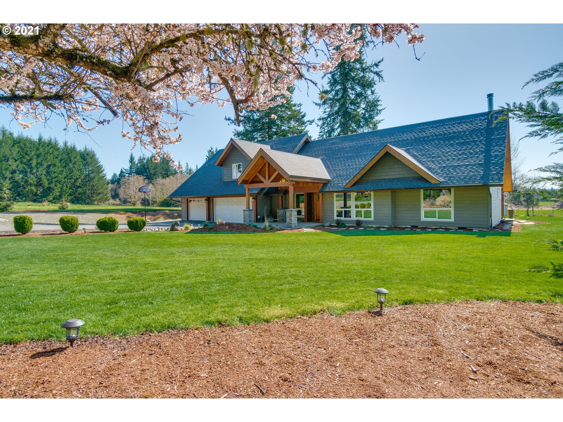 a front view of a house with a garden