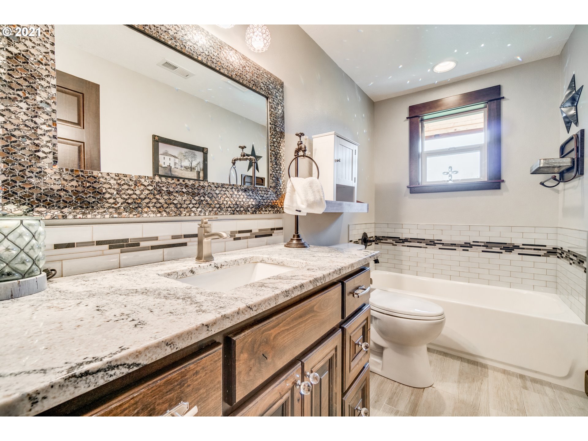 47280 Southeast Coalman Road Sandy, OR 97055 - Photo 15 of 32 a bathroom with a granite countertop sink a toilet a mirror and bathtub