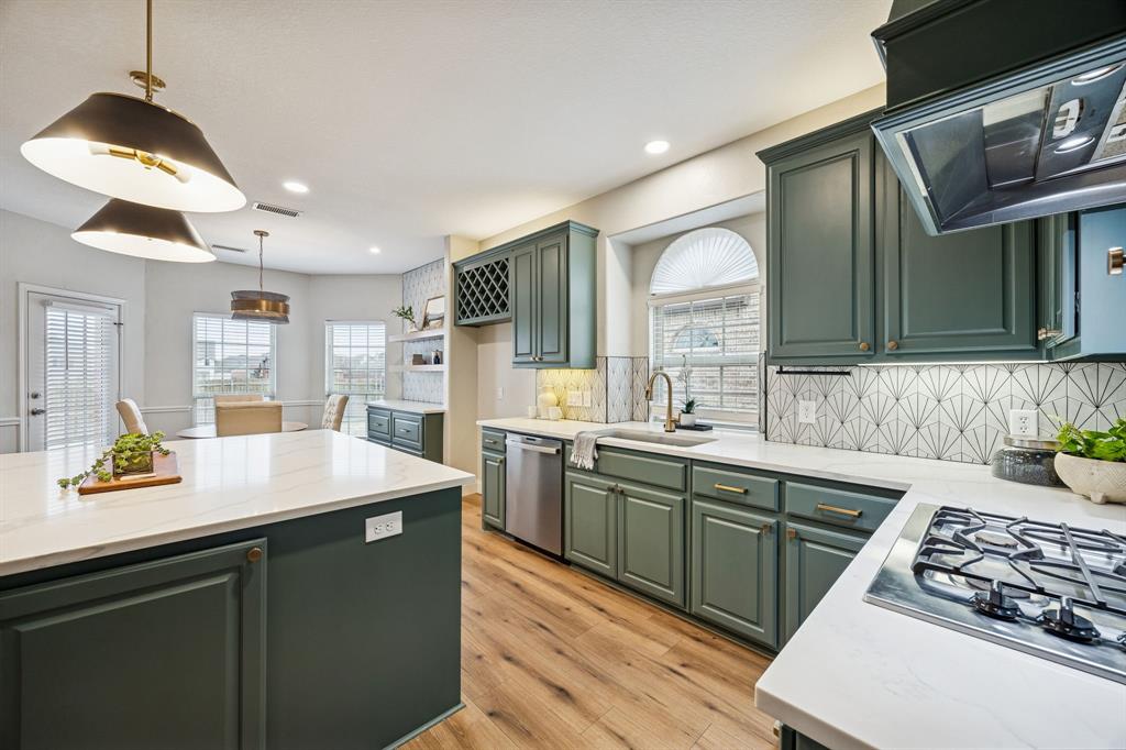 3608 Acropolis Way Plano, TX 75074 - Photo 12 of 40 a kitchen with stainless steel appliances granite countertop a sink stove and cabinets