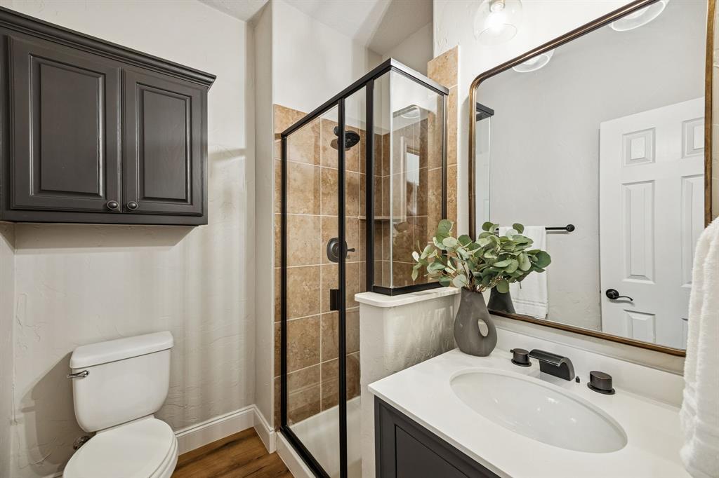 3608 Acropolis Way Plano, TX 75074 - Photo 20 of 40 a bathroom with a sink a toilet and mirror