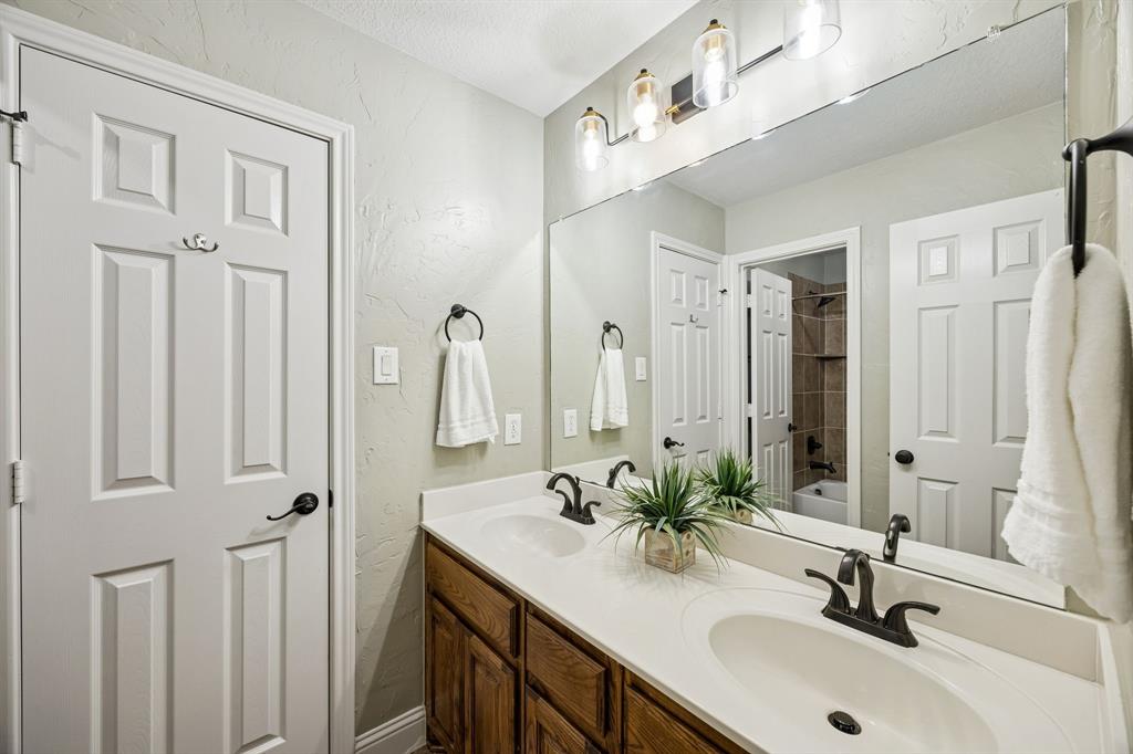 3608 Acropolis Way Plano, TX 75074 - Photo 27 of 40 a bathroom with a double vanity sink and a mirror