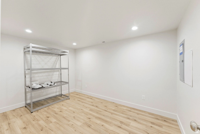 108 West Monte Rosa Lane Midway, UT 84049 - Photo 38 of 48 Spacious room featuring wood-finish flooring, white baseboards, recessed lighting, and a neutral color palette