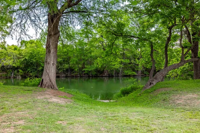 a wooden bench sitting next to a lake