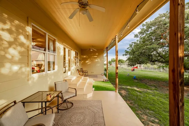 a view of a house with chairs potted plants