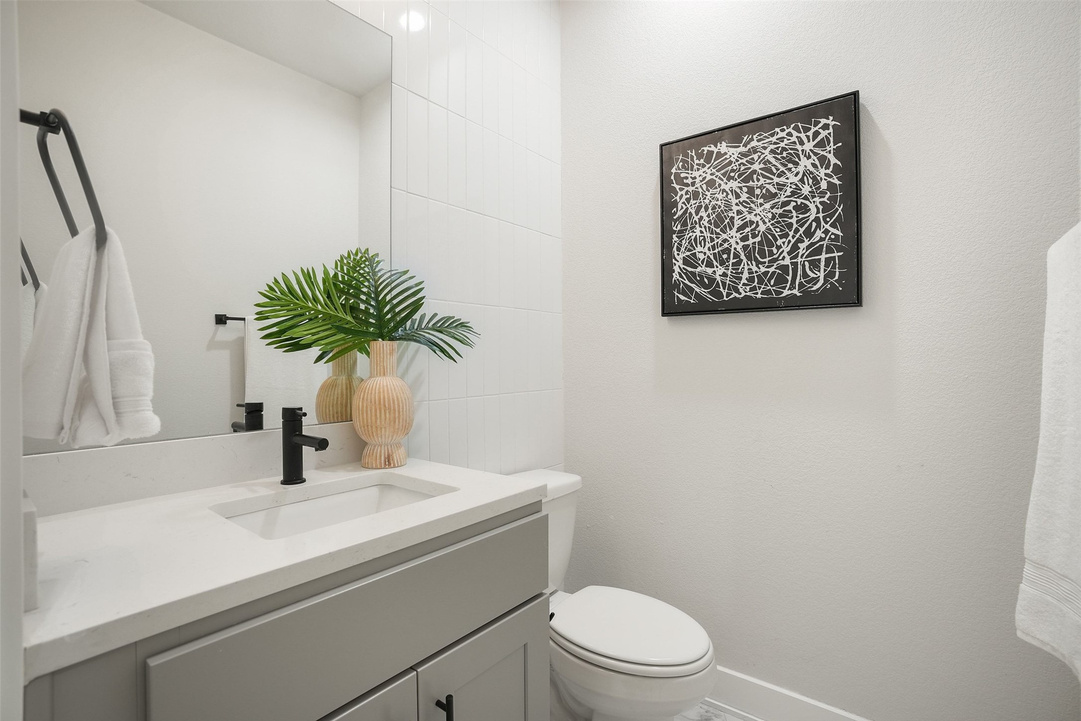 5109 Stone Gate Drive, Unit 2 Austin, TX 78721 - Photo 21 of 36 Bathroom featuring a rectangular undermount sink, light gray vanity cabinetry, light-toned countertop, and a matte black faucet