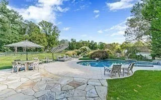 a view of a backyard with sitting area