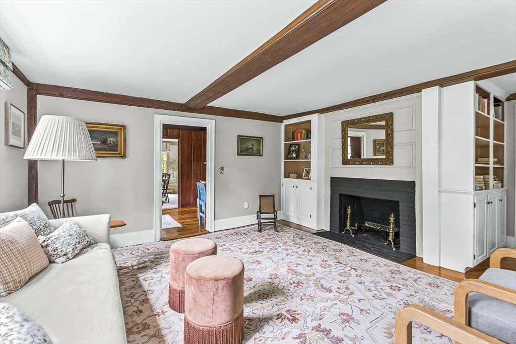60 Washington Street, Unit 60 Sherborn, MA 01770 - Photo 3 of 15 a living room with furniture and a fireplace