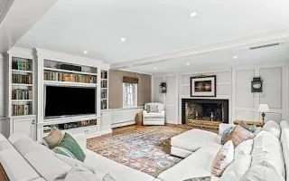 a living room with furniture flat screen tv and a fireplace