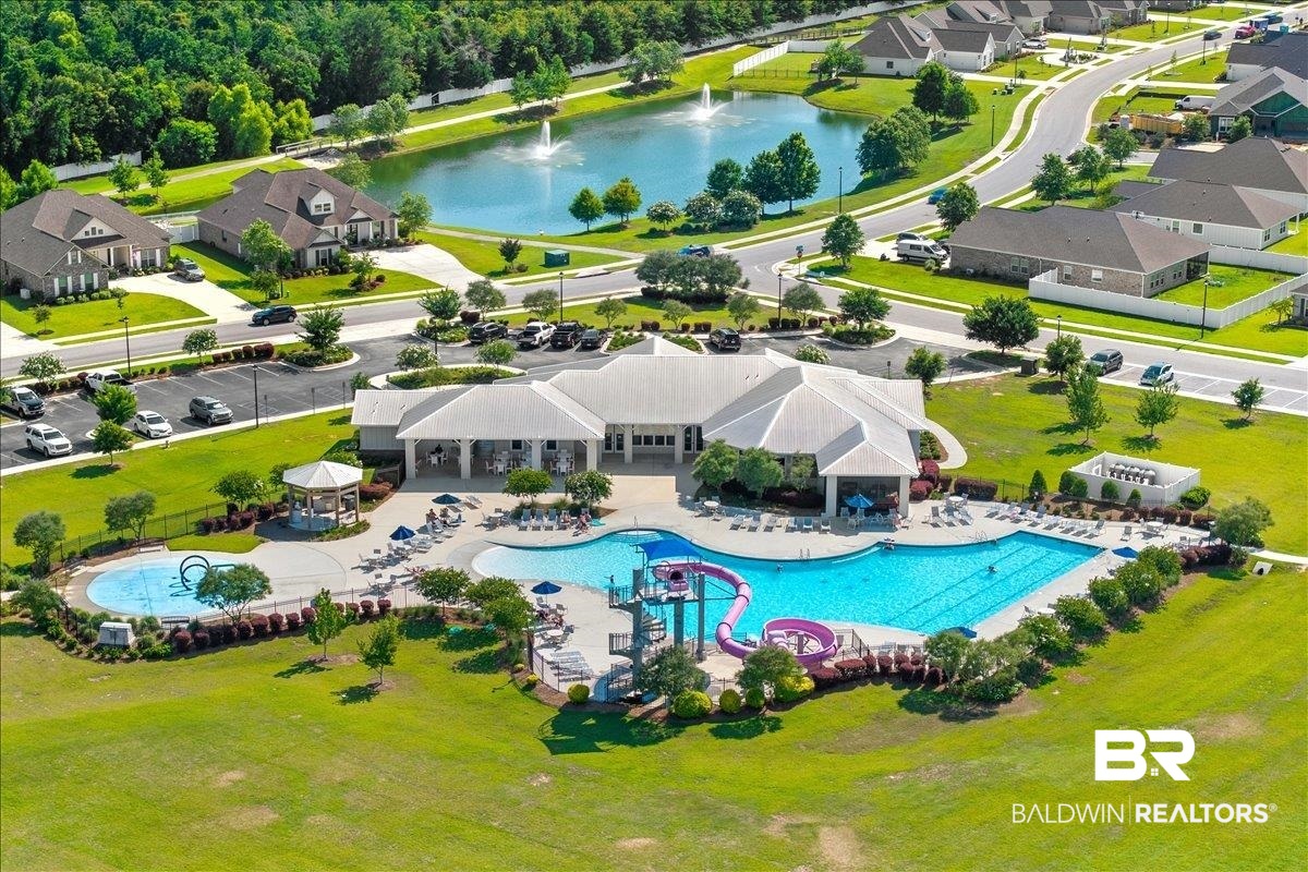 23641 Unbridled Loop Daphne, AL 36526 - Photo 37 of 40 Community clubhouse featuring multiple swimming pools, water slides, a splash pad, and a poolside gazebo