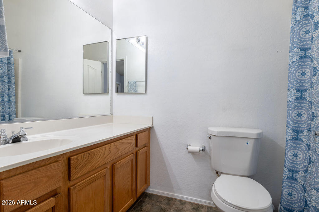 2024 South Baldwin, Unit 64 Mesa, AZ 85209 - Photo 13 of 25 a bathroom with a toilet sink and mirror