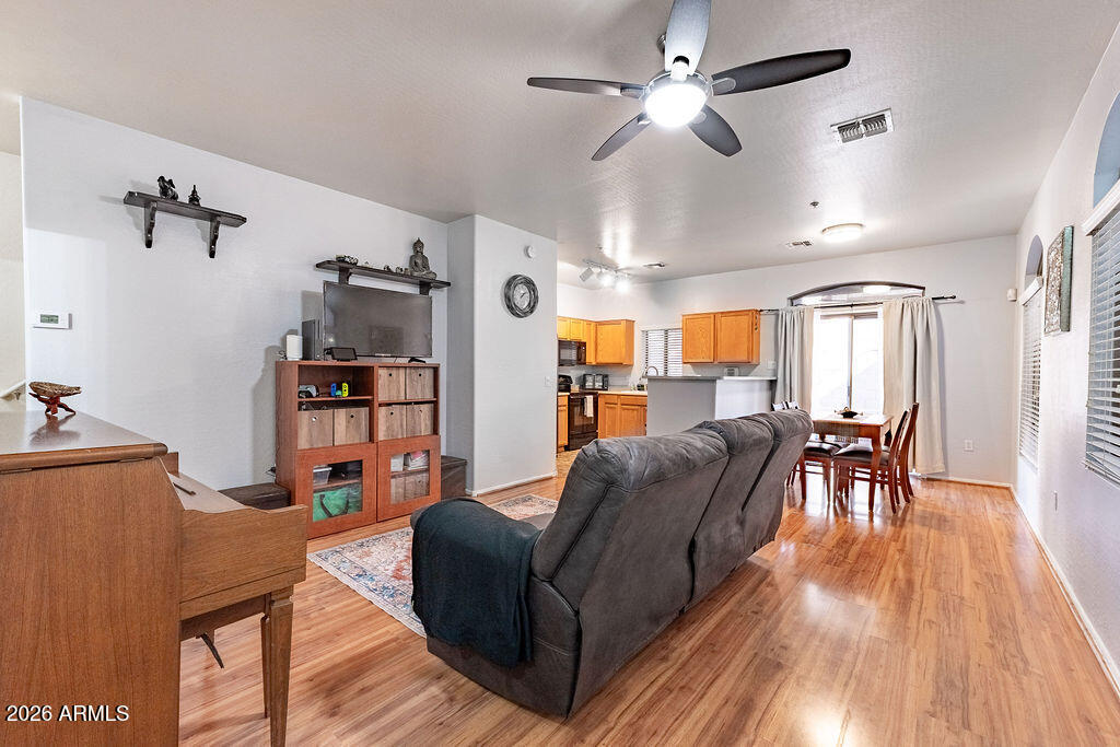 2024 South Baldwin, Unit 64 Mesa, AZ 85209 - Photo 3 of 25 a living room with furniture and a wooden floor