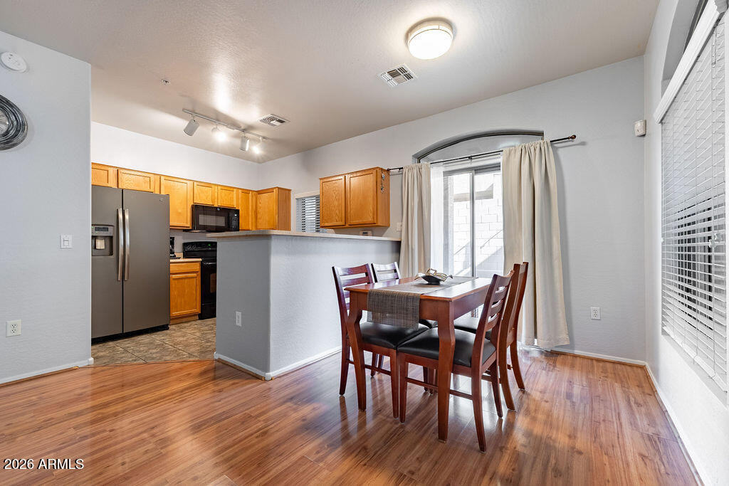 2024 South Baldwin, Unit 64 Mesa, AZ 85209 - Photo 5 of 25 a view of a dining room with furniture and wooden floor