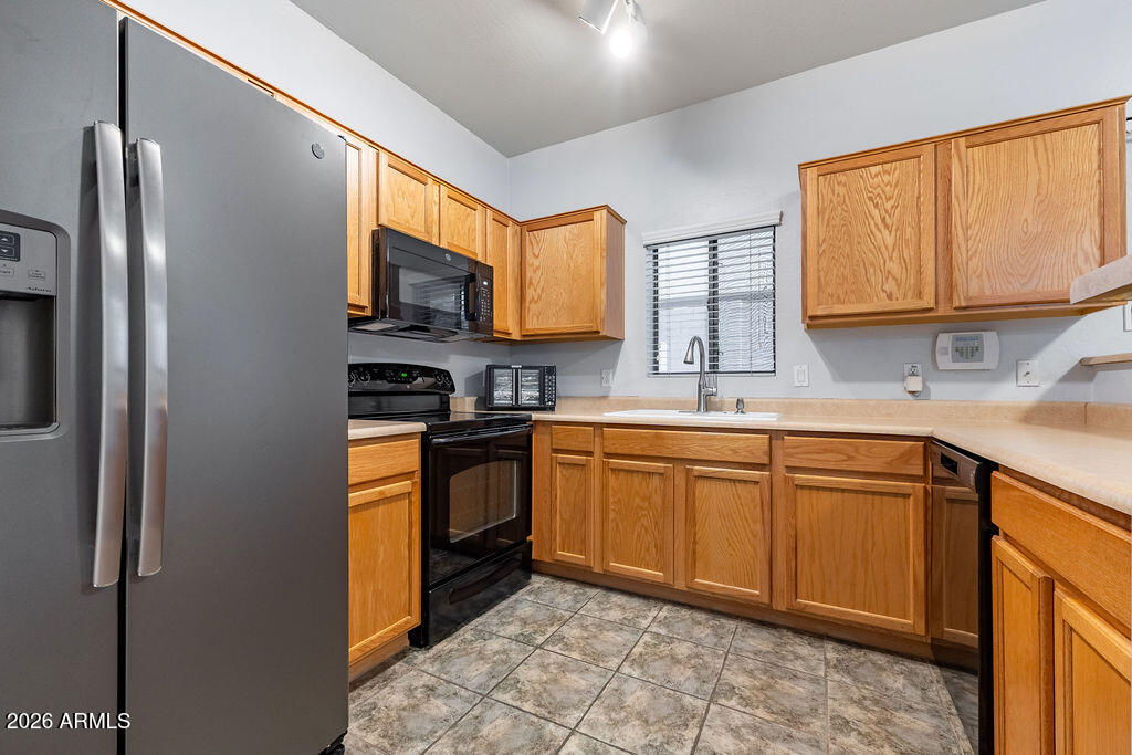 2024 South Baldwin, Unit 64 Mesa, AZ 85209 - Photo 6 of 25 a kitchen with stainless steel appliances granite countertop a sink stove and refrigerator