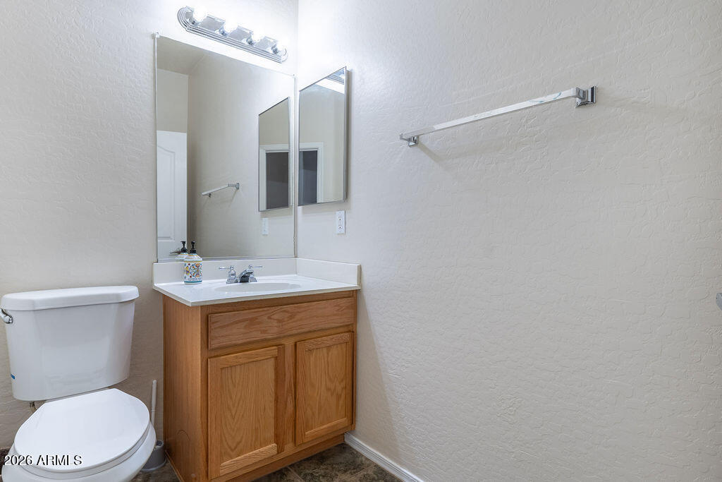 2024 South Baldwin, Unit 64 Mesa, AZ 85209 - Photo 7 of 25 a bathroom with a sink a toilet and mirror