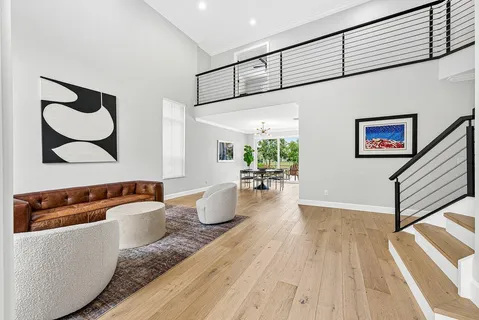 a living room with furniture and wooden floor