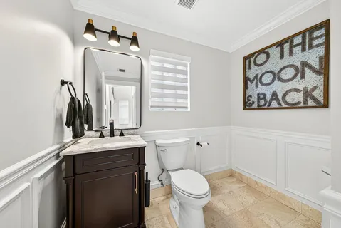 a bathroom with a toilet sink and mirror
