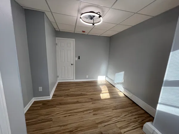 a view of a room with wooden floor