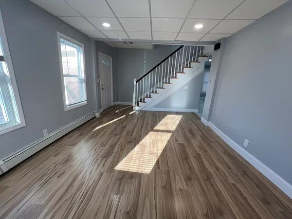 a view of entryway and hall with wooden floor