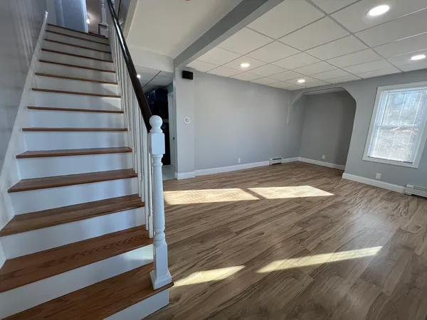 a view of entryway with wooden floor and stairs