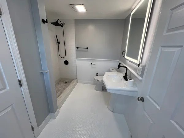 a bathroom with a sink toilet and shower