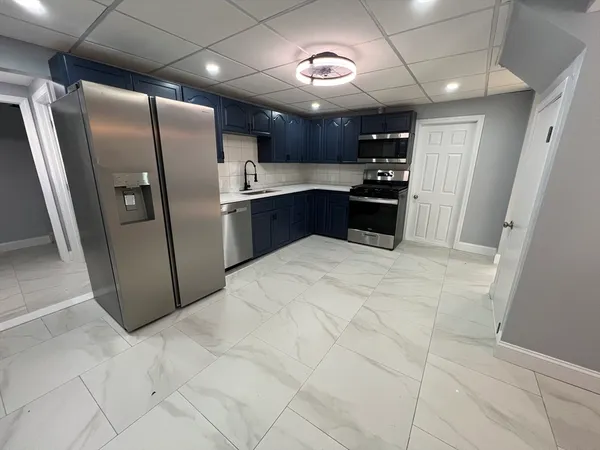 a kitchen with stainless steel appliances granite countertop a refrigerator and a sink