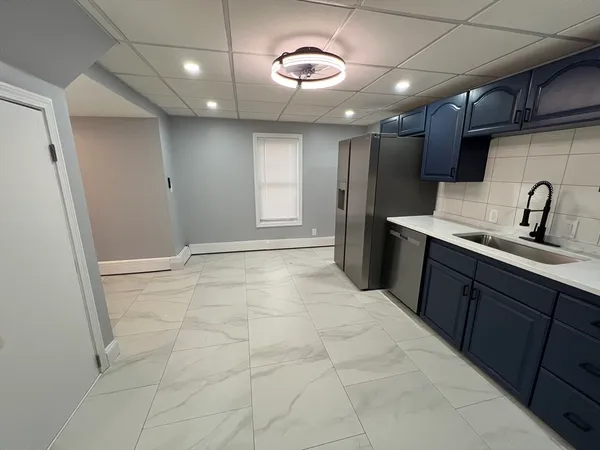 a kitchen with stainless steel appliances granite countertop a sink and a refrigerator