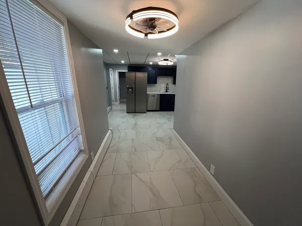 a view of a hallway with a kitchen