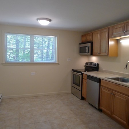 21 Folly Mill Road, Unit 2B Seabrook, NH 03874 - Photo 3 of 9 a kitchen with a sink cabinets and a window