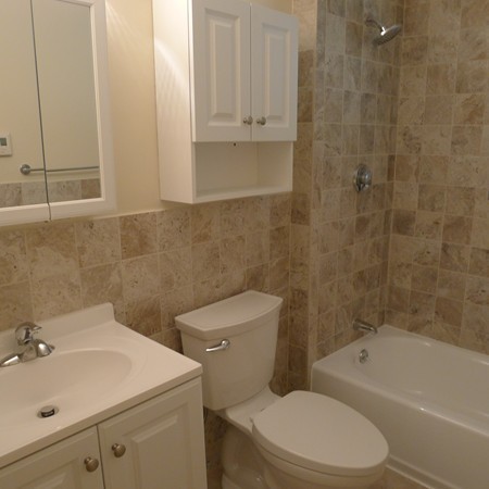 21 Folly Mill Road, Unit 2B Seabrook, NH 03874 - Photo 5 of 9 a bathroom with a sink a toilet and bathtub