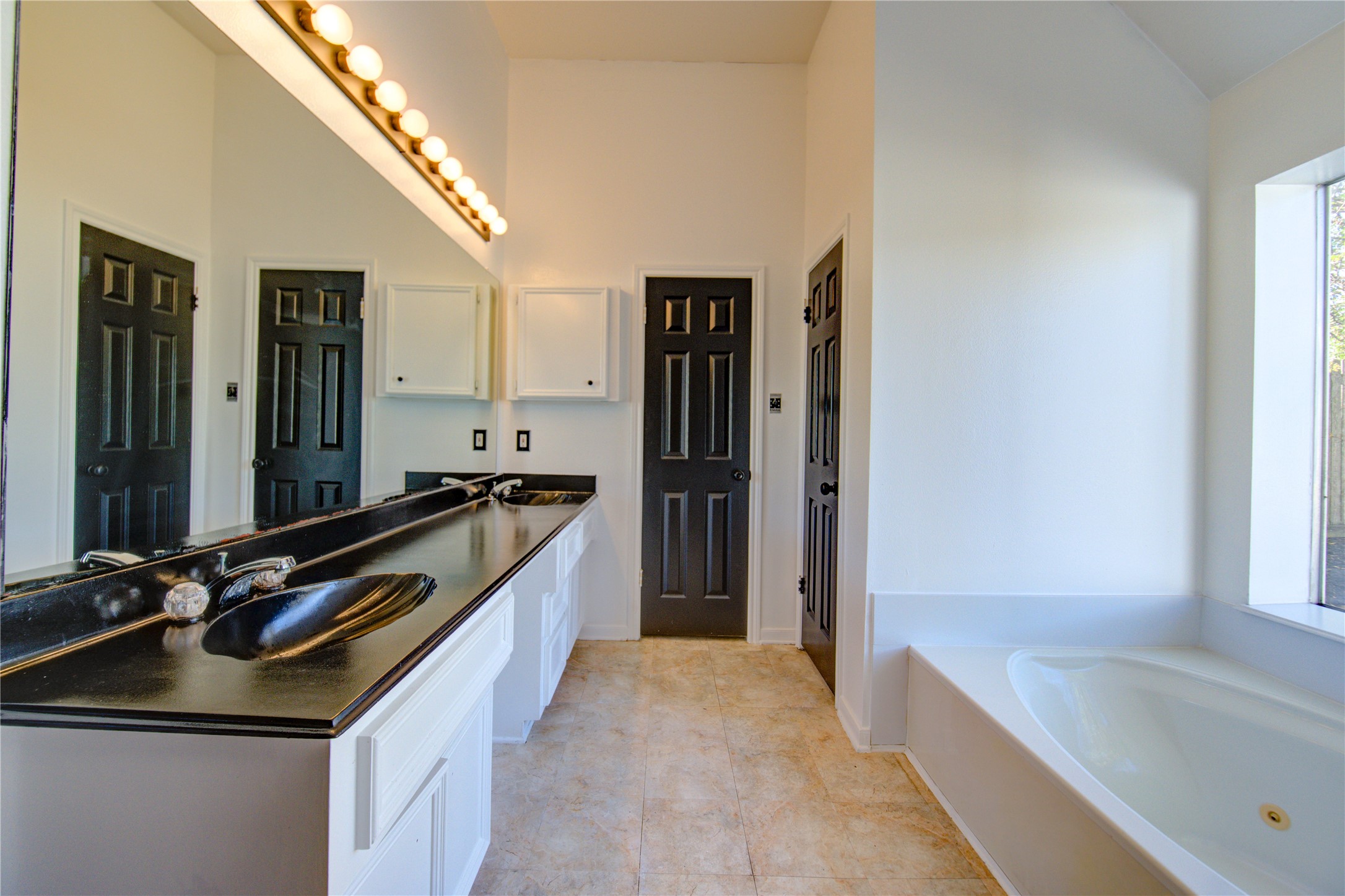 5931 Thom Road Humble, TX 77346 - Photo 14 of 18 a kitchen with a sink refrigerator and cabinets