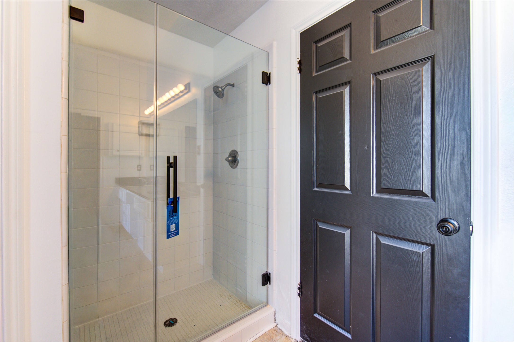 5931 Thom Road Humble, TX 77346 - Photo 15 of 18 a bathroom with a glass shower door