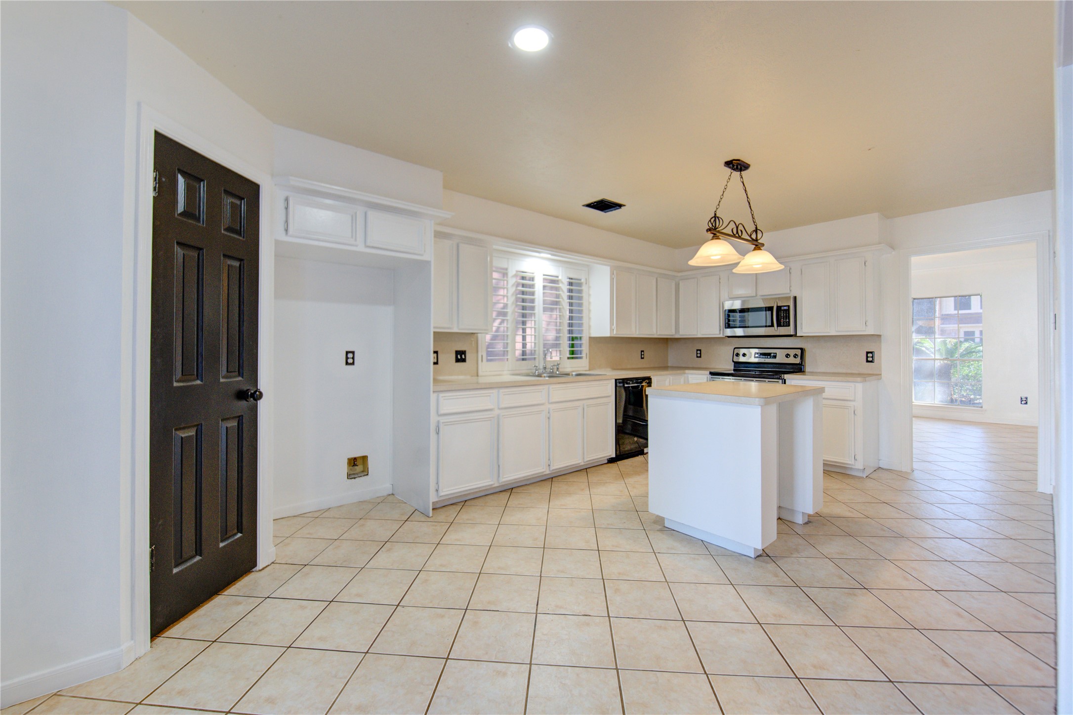 5931 Thom Road Humble, TX 77346 - Photo 6 of 18 a kitchen with cabinets and steel appliances