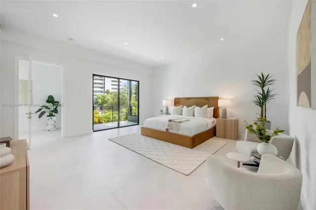 a spacious bedroom with a bed and a couch