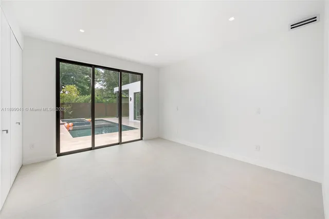 a view of an empty room with glass door