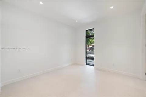 a view of an empty room with closet