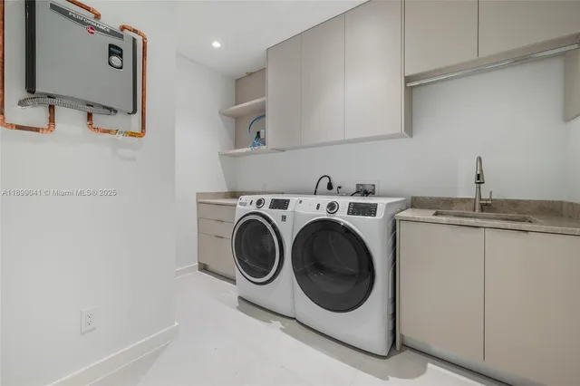 a utility room with sink dryer and washer